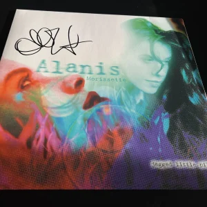 ALANIS MORISSETTE SIGNED AUTOGRAPH VINYL JAGGED LITTLE PILL IRONIC BECKETT BAS E