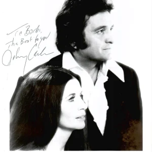 JOHNNY CASH SIGNED 8x10 PHOTO      GREAT POSE WITH HIS WIFE     RARE     JSA LOA