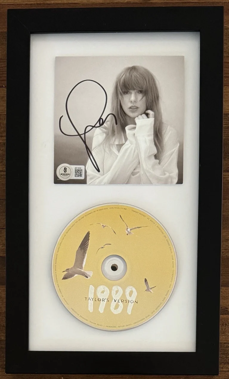 TAYLOR SWIFT SIGNED FRAMED PHOTOGRAPH & 1989 YELLOW CD BAS BECKETT COA AUTOGRAPH