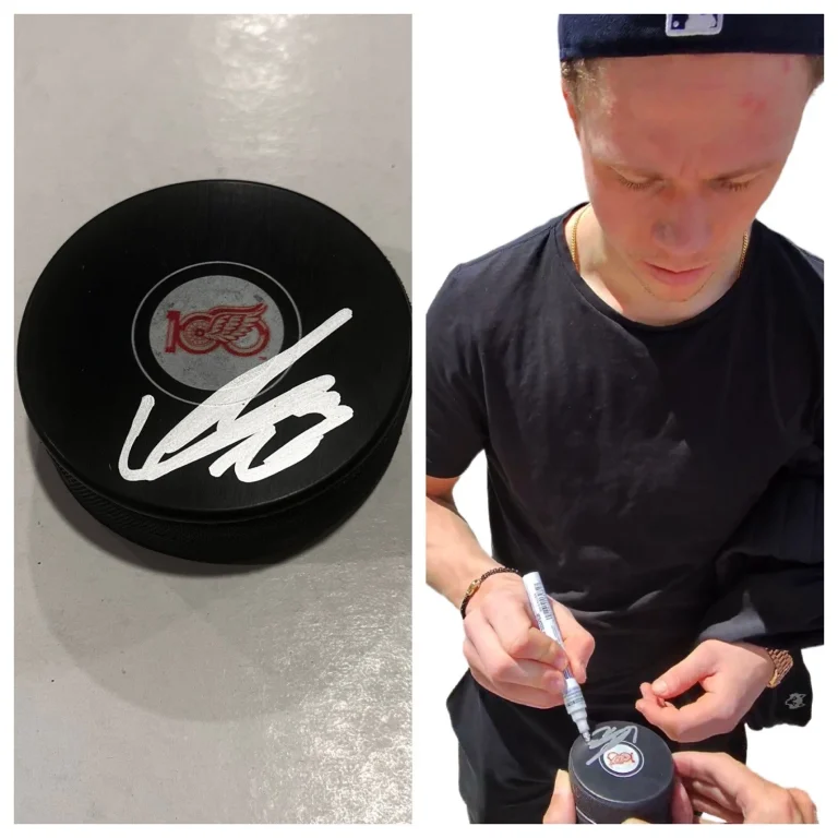LUCAS RAYMOND SIGNED DETROIT RED WINGS HOCKEY PUCK W/ CASE COA