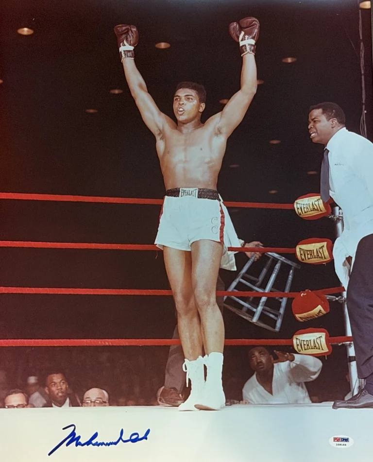 MUHAMMAD ALI SIGNED 16X20 PSA DNA BOTH ARMS IN AIR GOAT I09164
