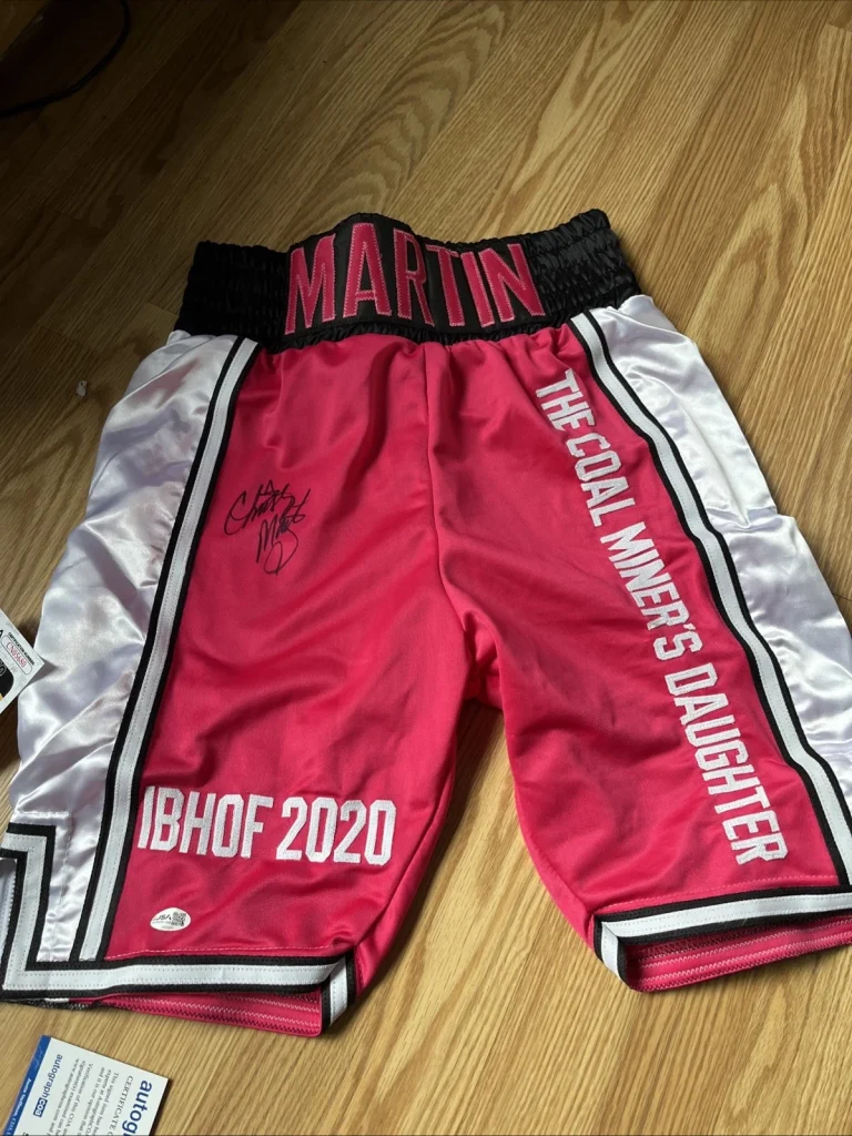 BOXING CHAMPION CHRISTY MARTIN SIGNED AUTOGRAPHED BOXING TRUNKS JSA COA HOF GOAT