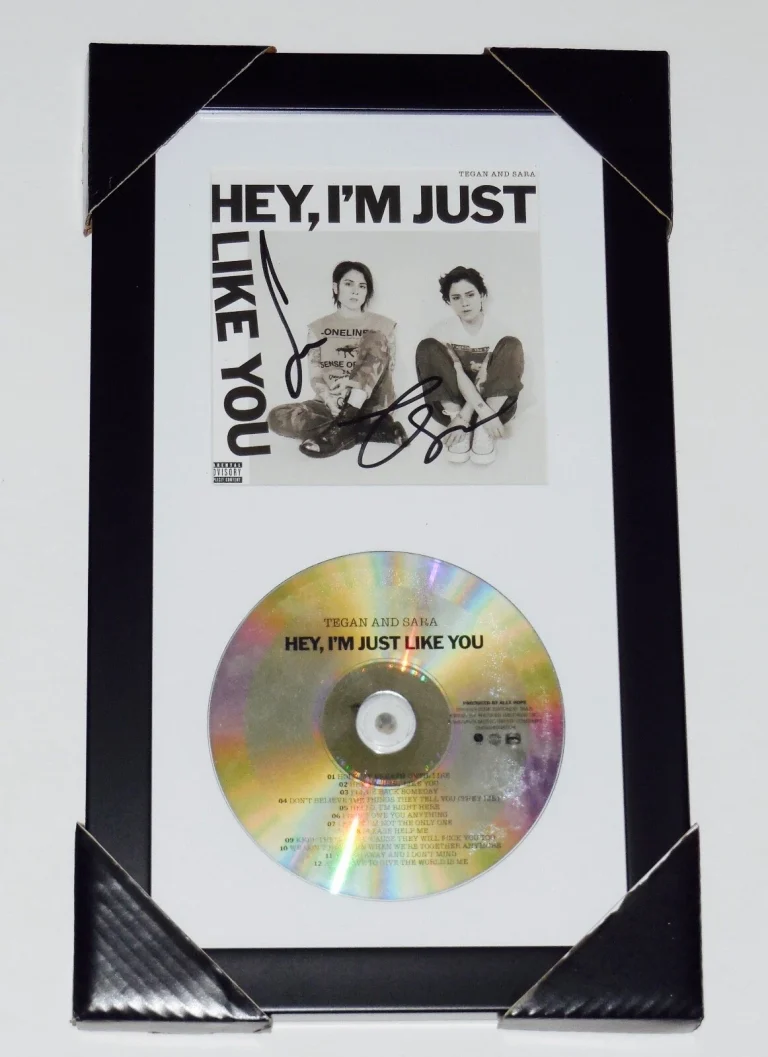 TEGAN & SARA AUTOGRAPHED HEY I'M JUST LIKE YOU CD COVER (FRAMED & MATTED) - COA!