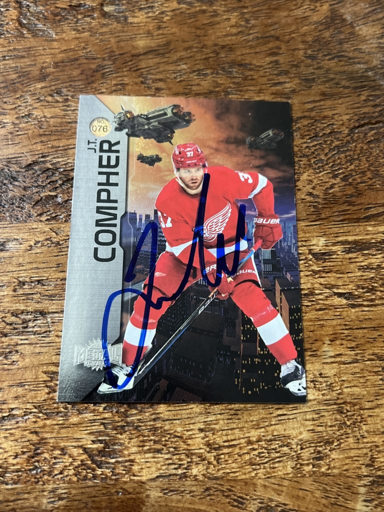 JT Compher IP Signed 2023-24 SkyBox Metal Universe Card Red Wings Autographed